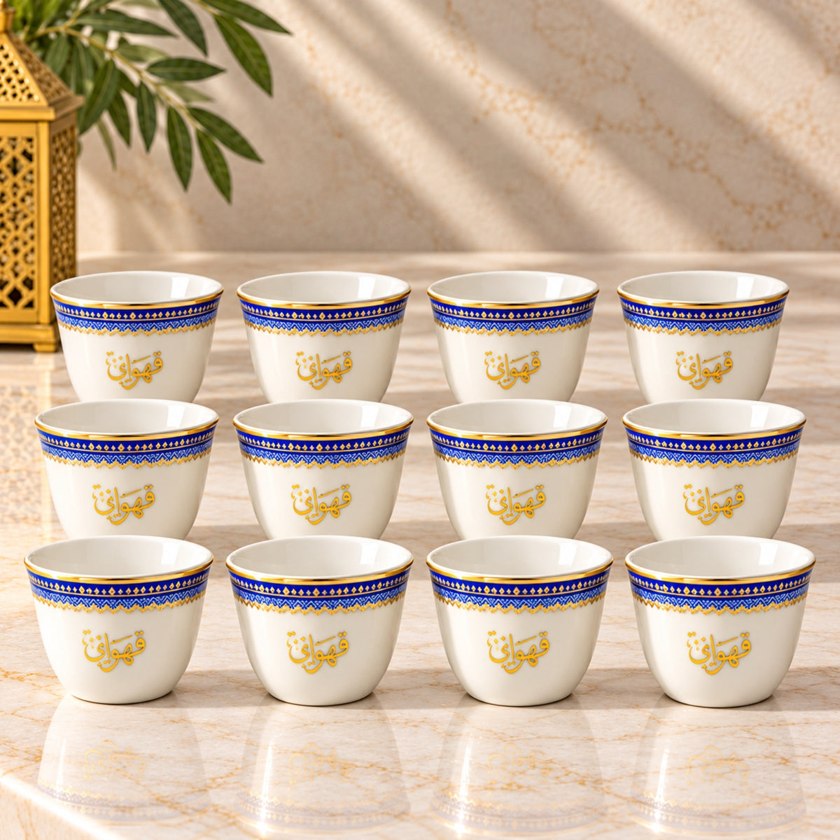 12-piece Arabic Cawa cup set in white with royal blue geometric borders, gold detailing and Arabic calligraphy for traditional coffee serving