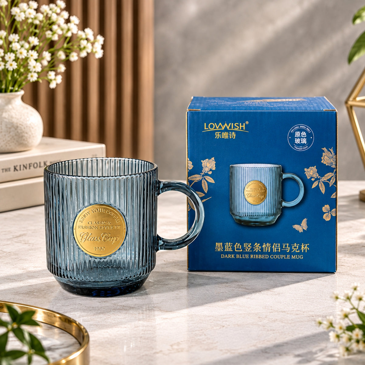 Dark blue ribbed Buck glass cup with handle and decorative gold-tone medallion