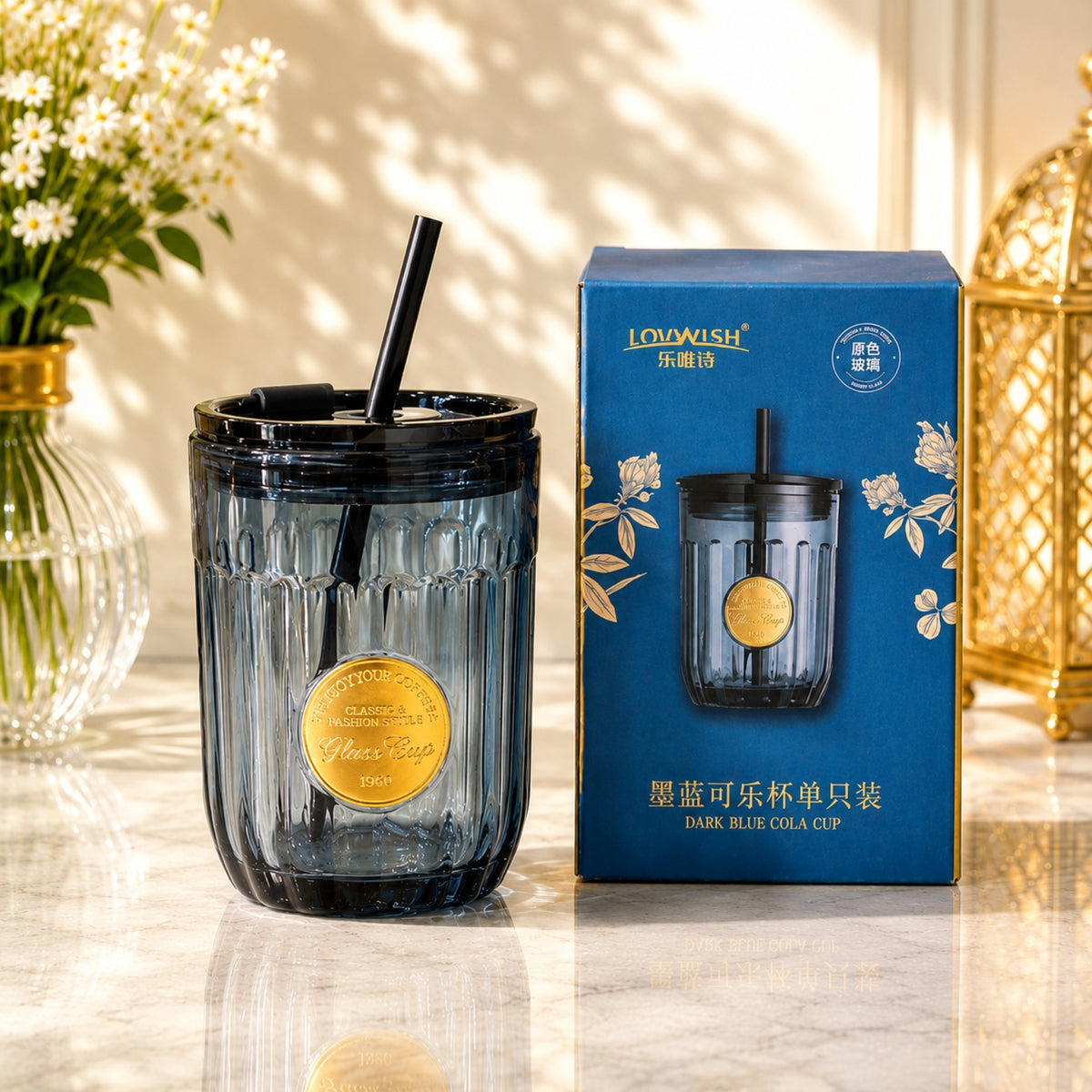 Dark blue cola glass cup with vertical fluted design, gold-tone medallion, lid and straw