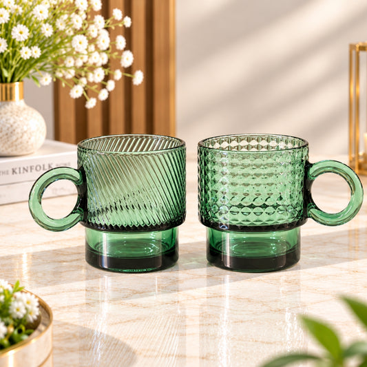 Dark green glass stacking cups 2-piece set with ribbed and geometric textured designs and round handles
