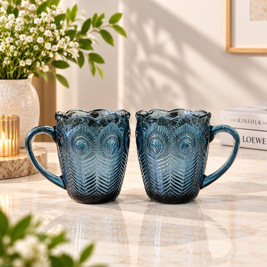 Dark blue peacock glass cup 2-piece set with embossed feather pattern, scalloped rims and curved handles