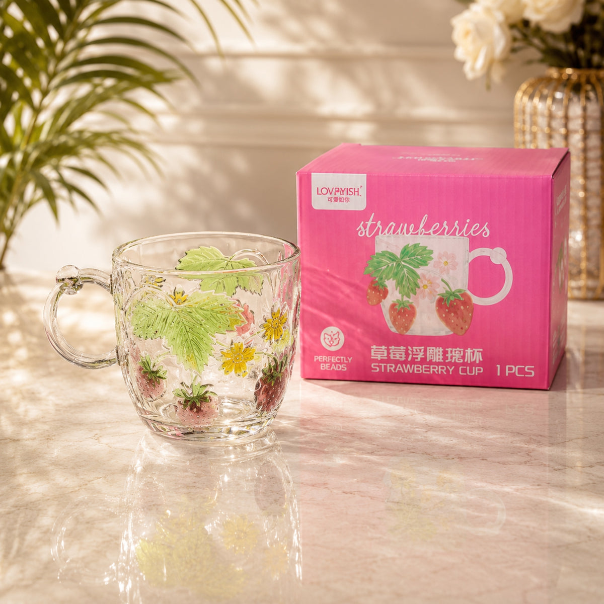 Strawberry embossed clear glass cup with handle featuring pink strawberries, green leaves and floral details