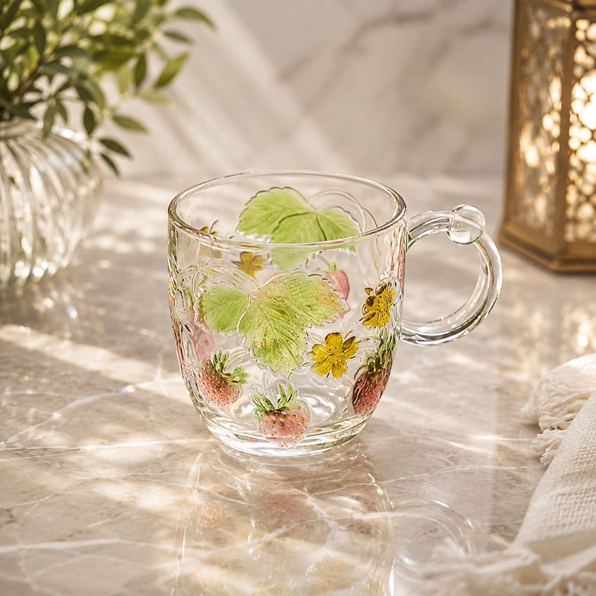 Strawberry embossed clear glass cup with handle featuring pink strawberries, green leaves and floral details